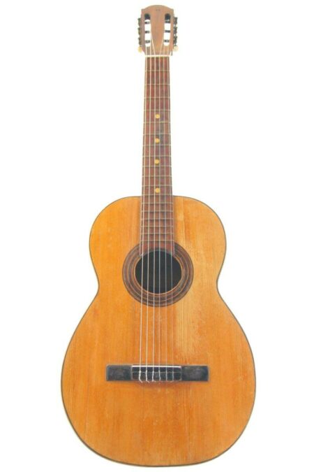 The Juan Galan Caro 1896 Romantic Guitar is a classical acoustic guitar with a wooden body, six strings, a round sound hole, and slotted headstock, shown against a white background.