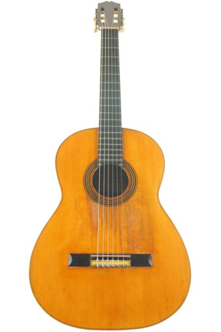 The Marcelo Barbero 1941 Flamenco Guitar features a wooden body, six strings, black fretboard, and gold tuning pegs, shown from the front on a white background.