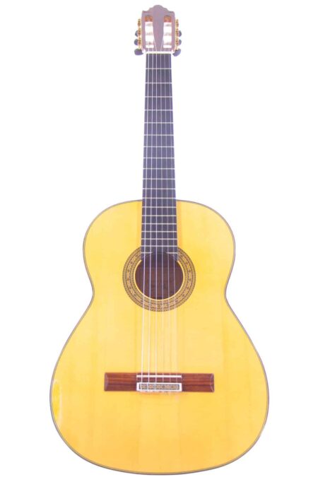 A Vicente Carrillo 2014 Flamenco Guitar featuring a light wood body, dark fingerboard, and decorative rosette is photographed against a white background.