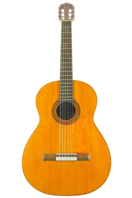 A Domingo Esteso 1921 classical guitar featuring a wooden body, six strings, dark fingerboard, and light brown finish is displayed against a white background.