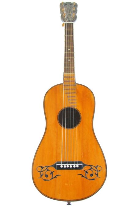 The Karl Frey Baroque Guitar features a natural wood finish, six strings, black decorative designs near the bridge, and a slotted headstock with tuning pegs.