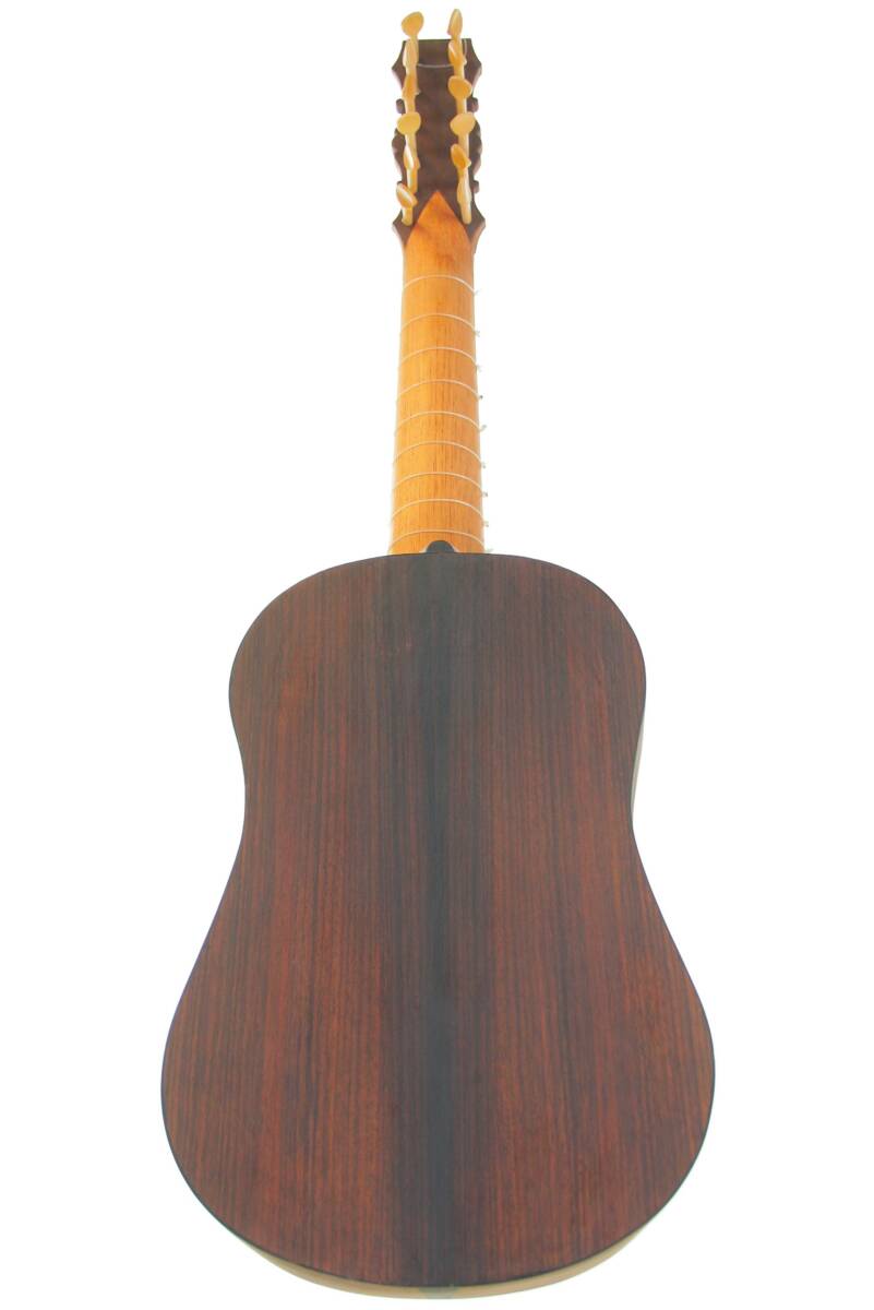Back View Of The Luis Milan Vihuela 1535/36 Highlighting Its Smooth Dark Wood Body And Contrasting Light Wood Neck With Tuning Pegs On Top.
