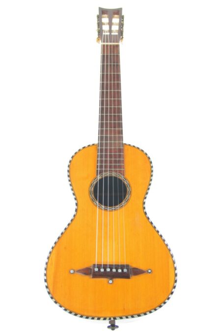 The Guyot (Guiot) 1849 Romantic Guitar features a light brown wooden body, dark brown neck and headstock, and black-and-white edge trim, displayed against a plain white background.