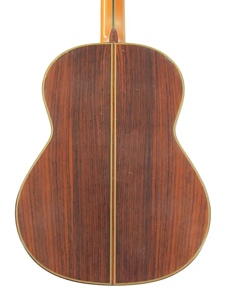 Die Manuel Rodriguez Jr Klassische Gitarre Hat Eine Glatte, Dunkelbraune Rückseite Mit Helleren Verzierungen, Die Ihre Kurven Umreißen, Und Einer Vertikalen Mittelnaht.