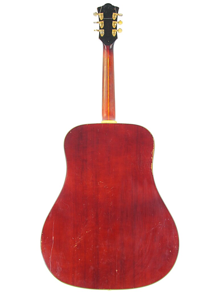 The Image Shows The Back Of A Guild D-44 1967 Acoustic Guitar With A Reddish-Brown Wooden Body, Darker Neck, Gold Tuners, And Visible Scratches And Wear.