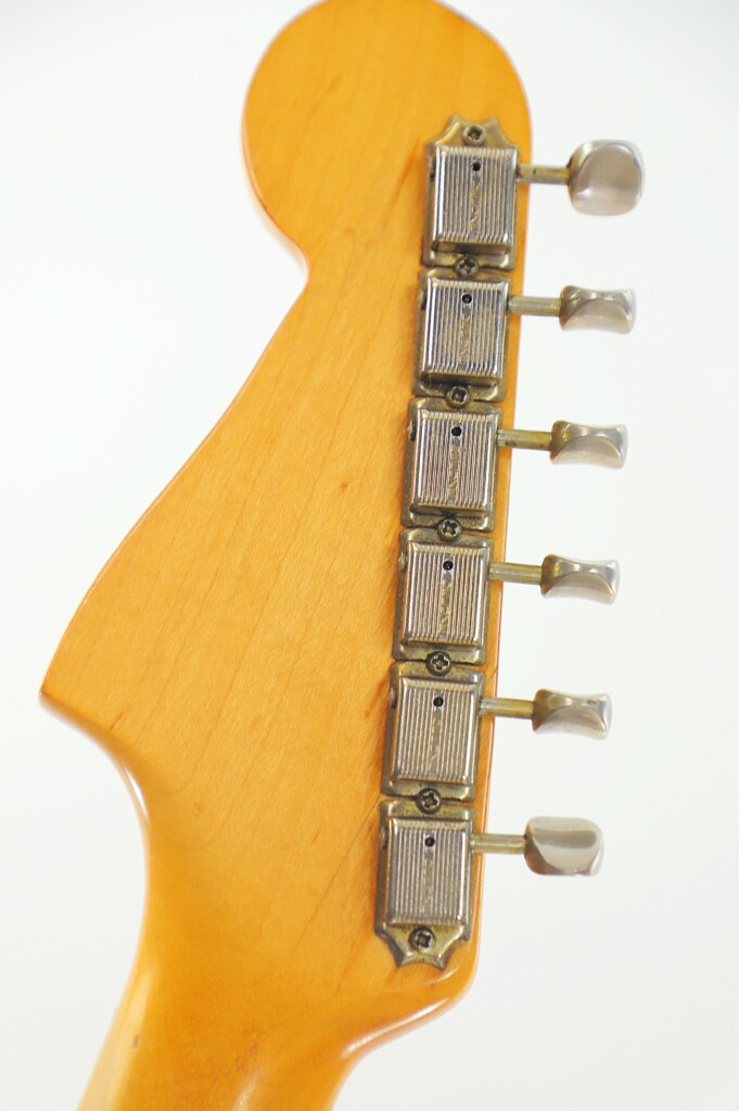 Close-Up Of The Fender Jazzmaster 1963 Electric Guitar Headstock Back, Displaying Six Silver Tuning Pegs On A Light Wood Finish.