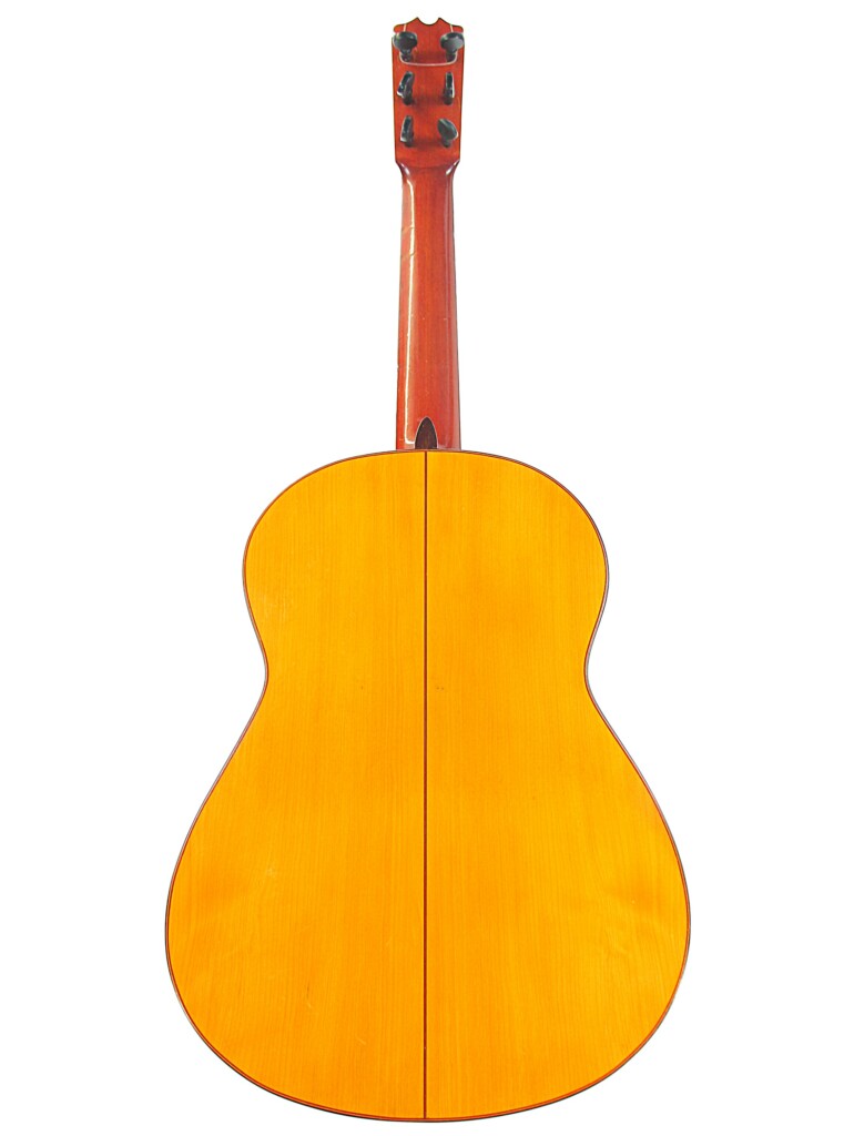 The Image Shows The Back Of A Hermanos Conde 1966 Faustino Conde Flamenco Guitar With A Smooth, Light Wood Finish, A Visible Center Seam, And Its Neck And Tuning Pegs In View.