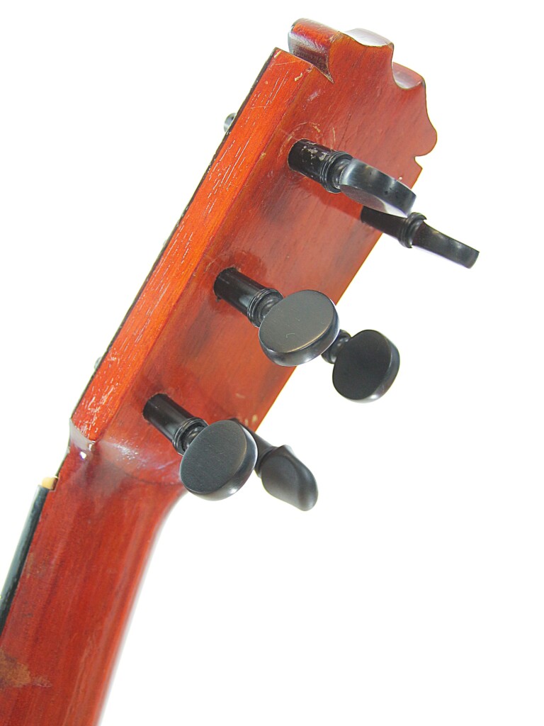 Close-Up Of The Headstock Of A Hermanos Conde 1966 Faustino Conde Flamenco Guitar, Featuring Wooden Tuning Pegs And Reddish-Brown Varnished Wood, Set Against A White Background.