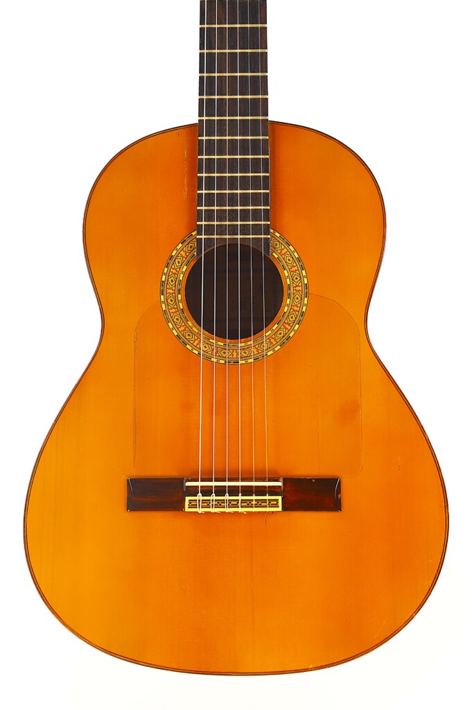 The Manuel G. Mayoral 1980 Flamenco Guitar Features A Wooden Body, Decorative Sound Hole Rosette, And Six Strings, Shown Against A White Background.
