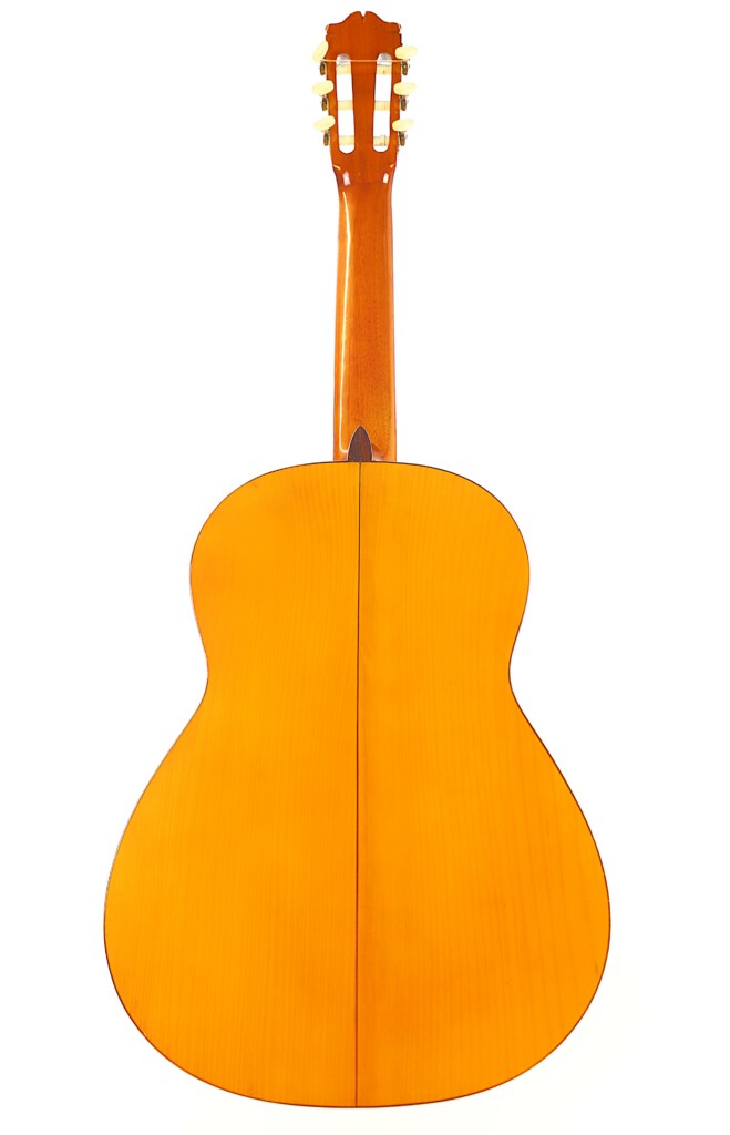 The Image Displays The Back Of A Manuel G. Mayoral 1980 Flamenco Guitar In Light Wood, Featuring Tuning Pegs And A Polished Finish. The Guitar Is Shown Vertically Against A White Background.