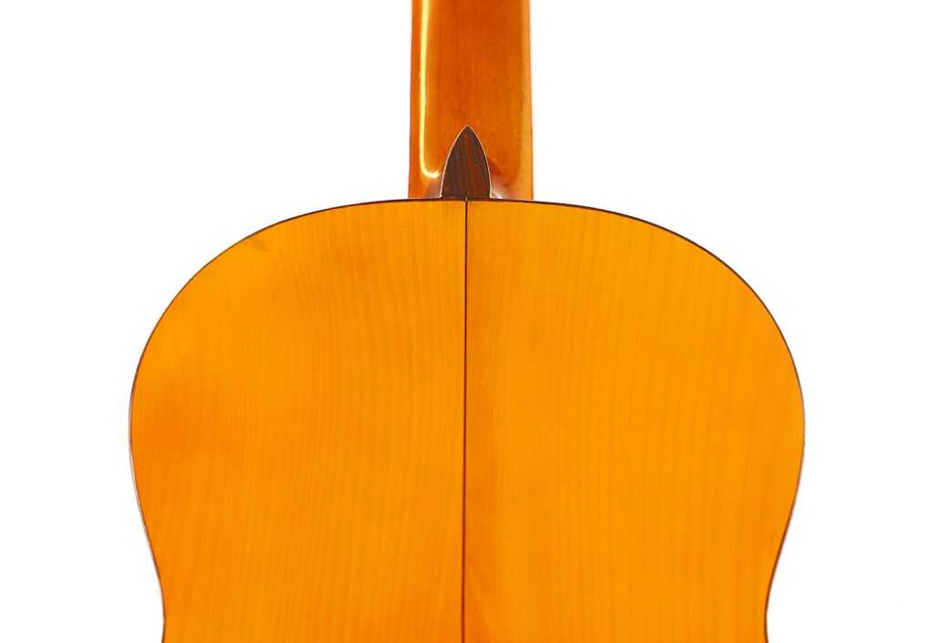 Close-Up Of The Back And Neck Of The Manuel G. Mayoral 1980 Flamenco Guitar, Showcasing Its Glossy Wooden Finish And Symmetrical Design Against A Plain White Background.