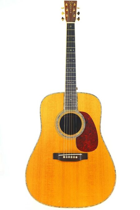 A full-length image of a Martin D-45 VR 1997 Acoustic Guitar featuring a natural wood finish, dark fretboard, six strings, and a red tortoiseshell-style pickguard is shown on a white background.