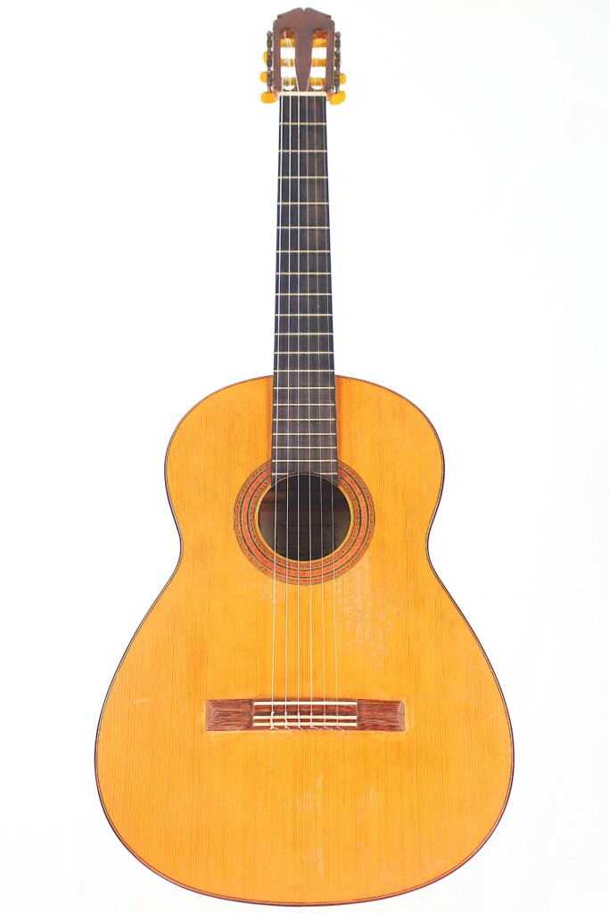 The Marcelino López Nieto 1954 Flamenco Guitar Features A Light Wood Body, Dark Fretboard, And Six Strings, Shown In A Photograph Against A Plain White Background.