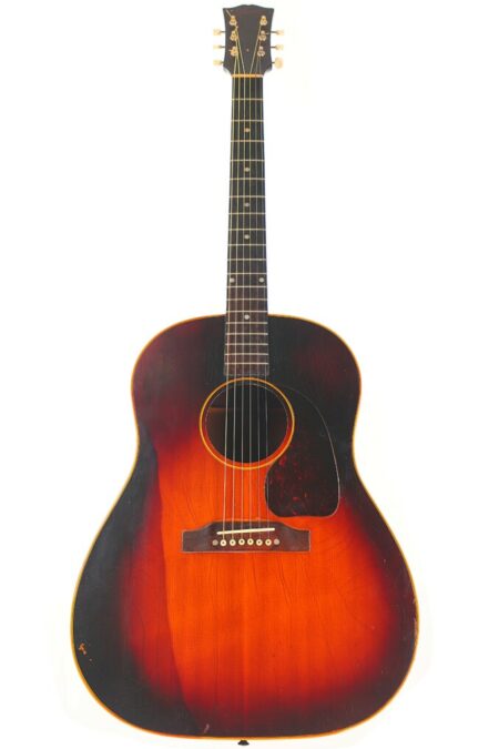 A Gibson J-45 1955 Acoustic Guitar with a sunburst finish and tortoiseshell pickguard is shown on a white background, its dark edges blending into a warm orange center.