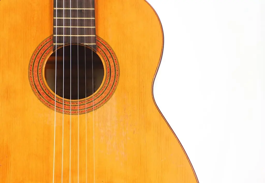 Close-Up Of A Marcelino López Nieto 1954 Flamenco Guitar’s Body And Strings Against A White Background, Showing The Sound Hole And Part Of The Fretboard On The Left.