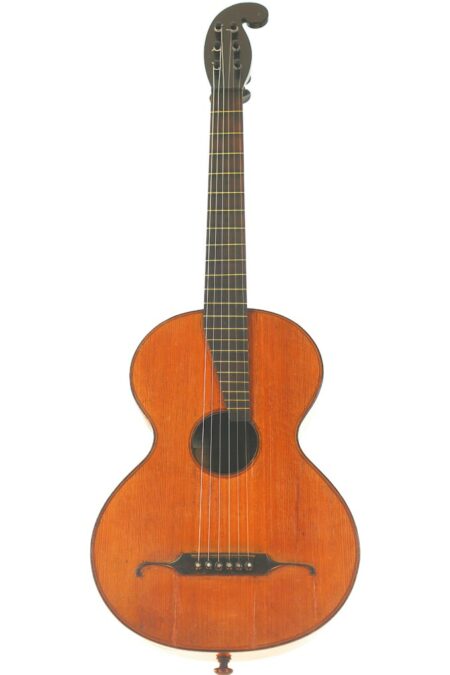 The Johann Bucher ~1830 Romantic Guitar features a rounded wooden body, dark circular sound hole, six strings, and a scroll-shaped headstock, shown against a white background.
