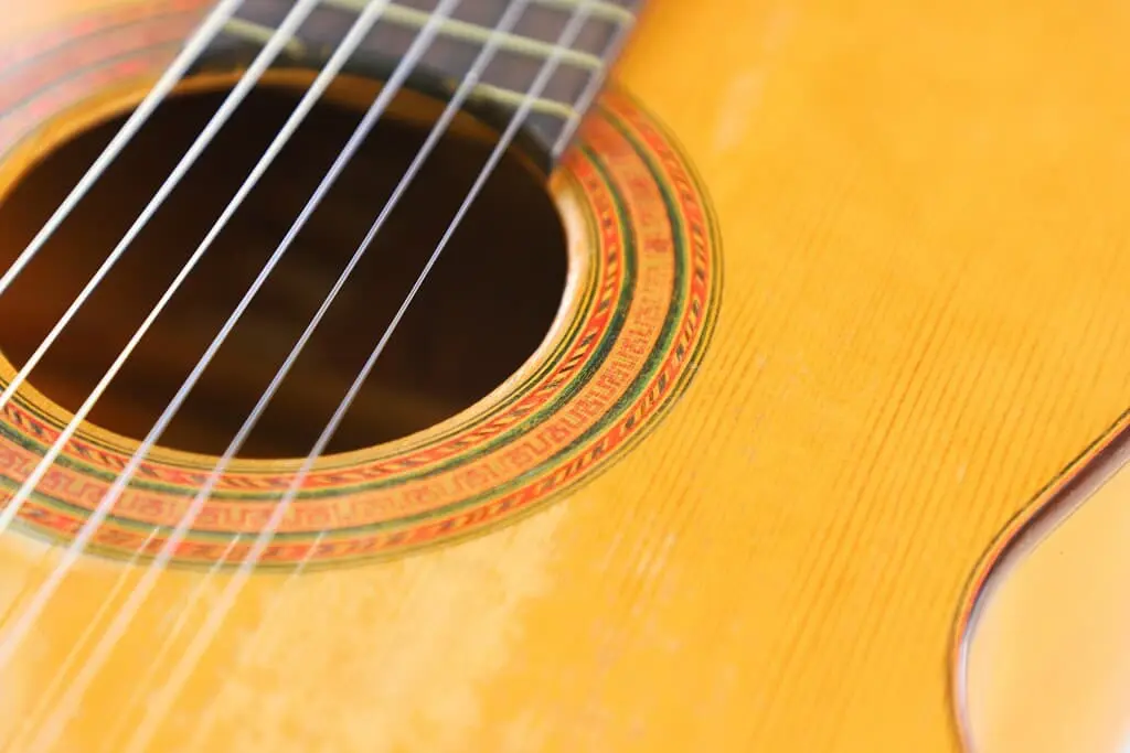 Close-Up Of The Marcelino López Nieto 1954 Flamenco Guitar, Highlighting Its Strings, Sound Hole With Decorative Rosette, And Part Of The Wooden Body.