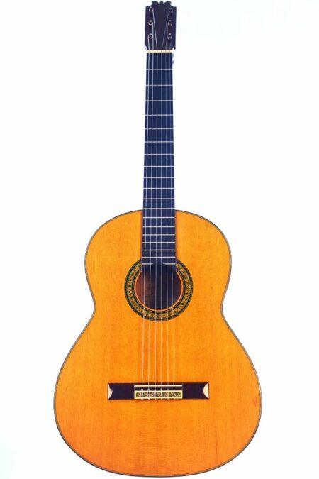 The Pedro Maldonado 1975 Paco de Lucia Flamenco Guitar features a wooden body, dark fretboard, six strings, and a decorative rosette, shown against a white background.