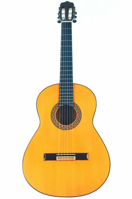 The Lorenzo Alvarez 1982 Flamenco Guitar features a wooden body, dark fretboard, and decorative rosette, shown against a white background.
