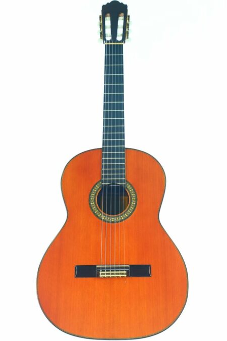 The Juan Estruch 1978 Classical Guitar, featuring a wooden body, dark fretboard, and nylon strings, is photographed on a white background.