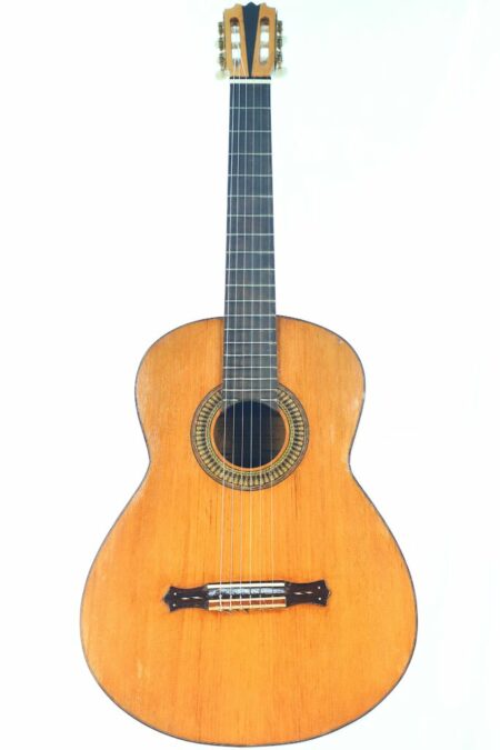 The Manuel Perez Paez 2000 Spanish Guitar features a wooden body, dark fretboard, six strings, and a decorative rosette around the sound hole, shown against a plain white background.
