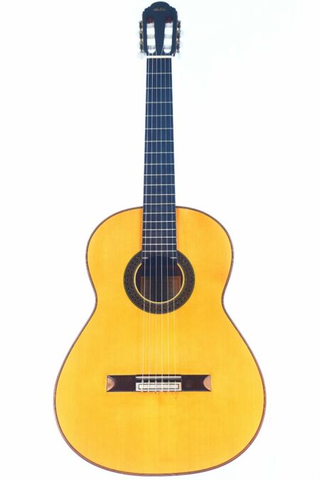 The Paco Santiago Marin 1983 classical guitar features a light wood body, dark wood fingerboard, and six strings, shown against a white background.