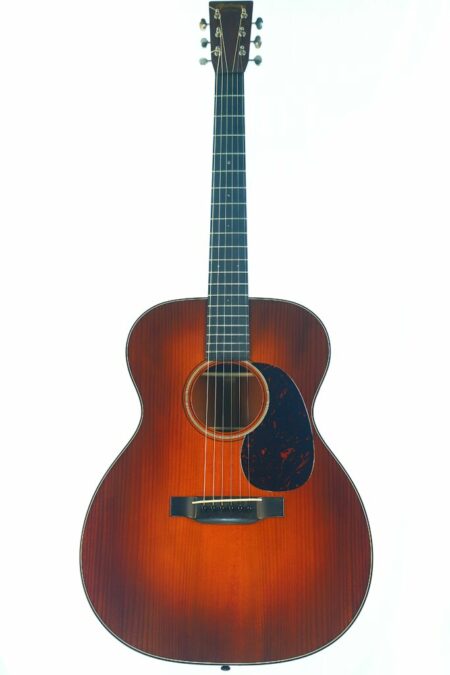 The Martin OM-18 OM Authentic 1933 Acoustic Guitar features a sunburst finish, dark edges, a pickguard, and six strings, and is photographed against a white background.