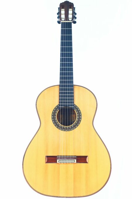The Manuel Ordono 2023 Blanca Flamenco Guitar features a light wood body, dark fretboard, and ornate soundhole detailing, shown against a plain white background.