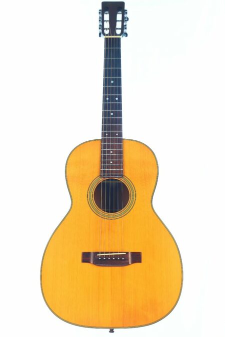 The Martin 00-21 1987 Acoustic Guitar features a natural wood finish, six strings, and a dark fingerboard, displayed against a plain white background.