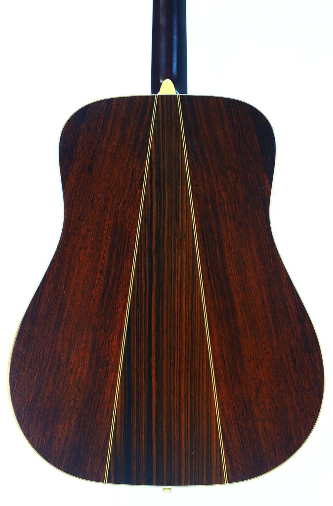 The Martin D-35 1979 Acoustic Guitar Features A Dark Wood Back With Two Thin, Light-Colored Vertical Inlays And A Glossy Finish That Reflects Light.