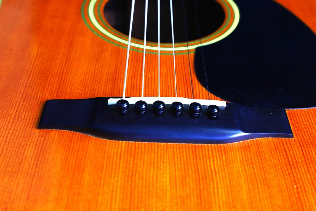 Close-Up Of A Martin D-35 1979 Acoustic Guitar, Highlighting The Strings, Bridge, And Part Of The Soundhole On Its Polished Wooden Body.
