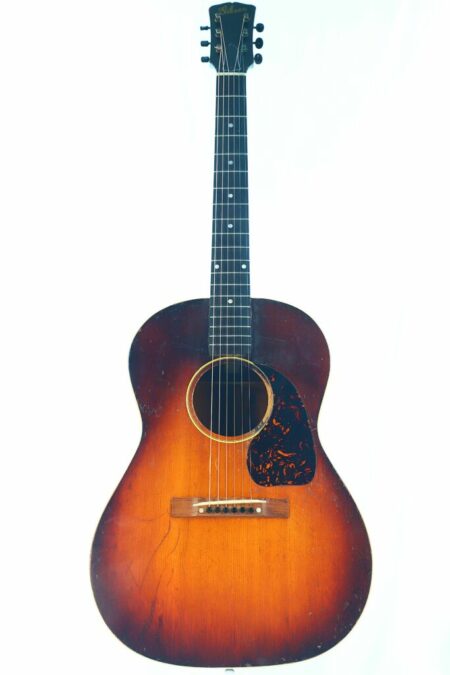 A 1946 Gibson LG-2 acoustic guitar with a sunburst finish, dark edges, round sound hole, and tortoiseshell pickguard, photographed against a plain white background.
