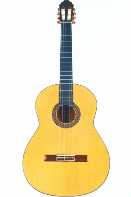 The Canete Y Hernandez 2005 Flamenco Guitar features a light-colored wooden body, dark fretboard, and six strings, captured against a plain white background.