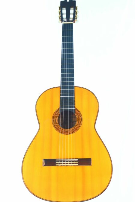 The Luis Sanchez 2002 Flamenco Guitar features a light wooden body, dark fretboard, and six strings, captured against a white background.