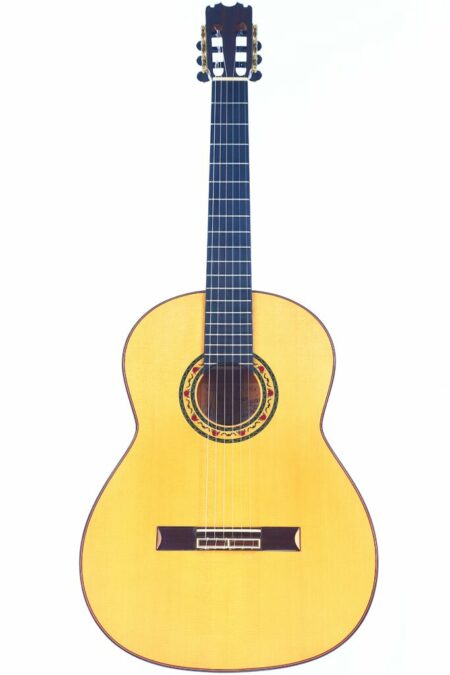 A Pena Vargas 2017 flamenco guitar with a light wooden body, dark fretboard, and decorative rosette around the sound hole is photographed on a white background.