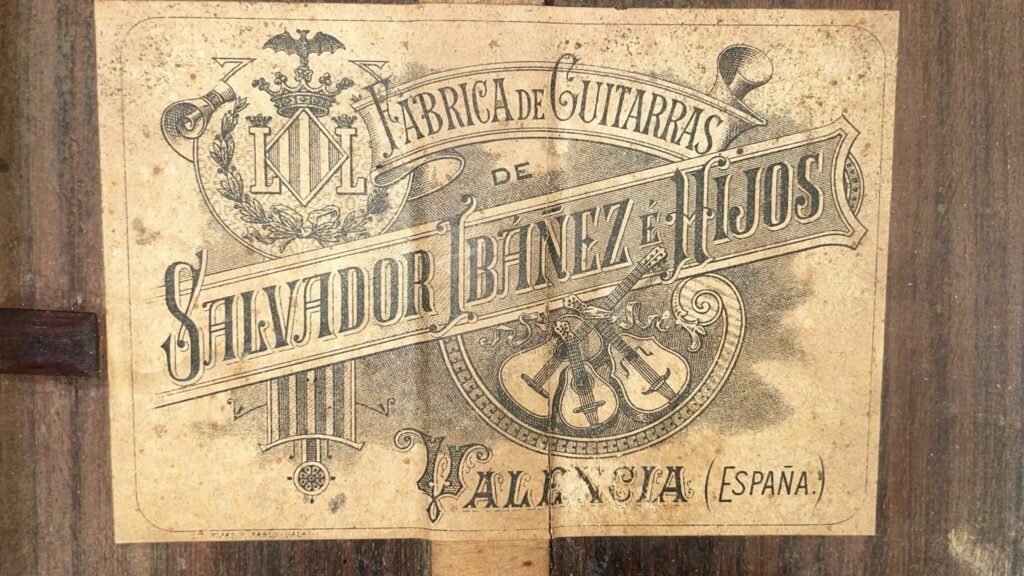 A Vintage Label With Ornate Typography And Guitar Illustrations On Aged Paper Captures The Elegance Of The Salvador Ibanez ~1900 Classical Guitar, Crafted By Fabrica De Guitarras De Salvador Ibáñez E Hijos, Valencia (España).