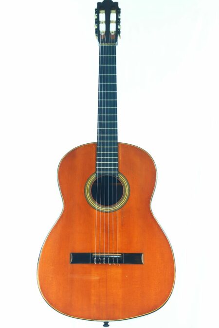 The Richard Jacob Weissgerber 1929 Torres Classical Guitar features a wooden body, dark fretboard, and six strings, displayed against a plain white background.