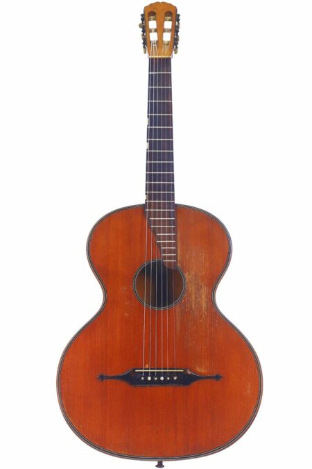 The Richard Jacob Weissgerber 1923 Classical Guitar features a wooden body, dark central sound hole, six strings, a classic shape, and a slotted headstock, displayed against a white background.
