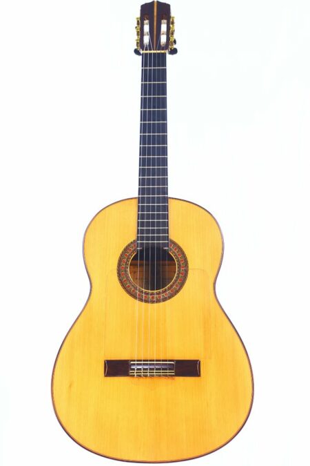 The Pedro Maldonado 1963 Negra Flamenco Guitar features a light wooden body, dark fretboard, and six strings, photographed against a plain white background.