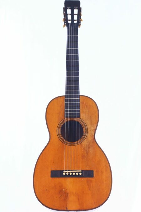 The Martin 3-18 1870 Acoustic Guitar, featuring a wooden body, dark neck, and six strings, is displayed upright against a white background.