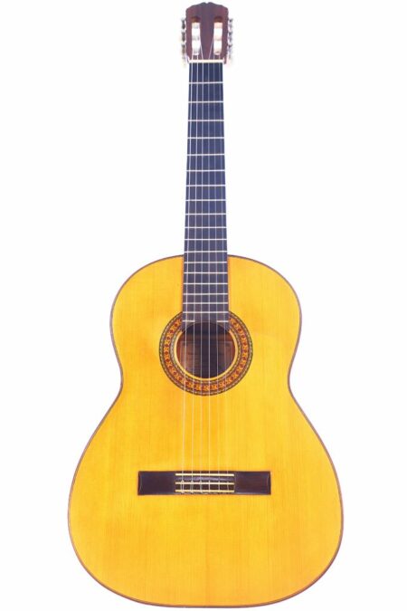 The Antonio Ortiz Romero 1970s Flamenco Guitar features a light wood body, dark fretboard, and decorative rosette around the sound hole, shown on a white background.