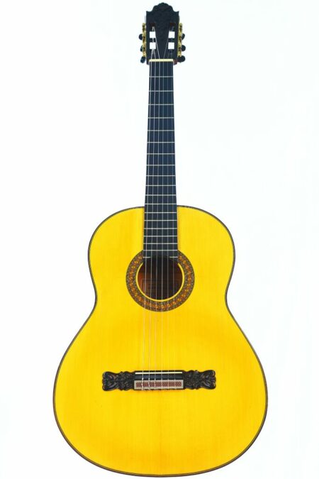 The Ruiz Pedregosa 2023 Flamenco Guitar features a bright yellow wooden body, ornate rosette, dark fretboard, and decorative bridge, displayed against a plain white background.