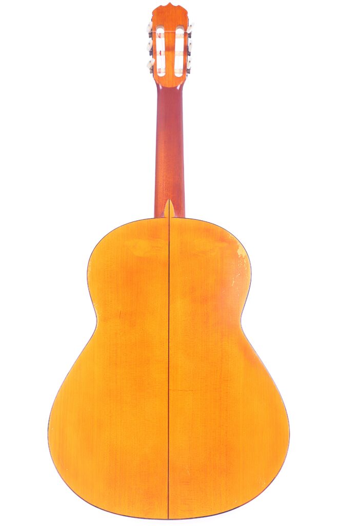 The Image Shows The Back View Of A Jose Ramirez 1968 Flamenco Guitar, Featuring A Light Wooden Finish With A Vertical Center Seam On The Body, Along With Visible Tuning Pegs And Headstock At The Top.