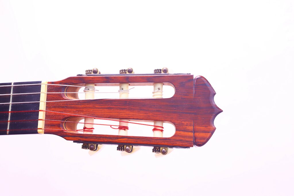 Close-Up Of The Headstock Of A Jose Ramirez 1968 Flamenco Guitar, Showing Tuning Pegs And Strings Against A White Background.