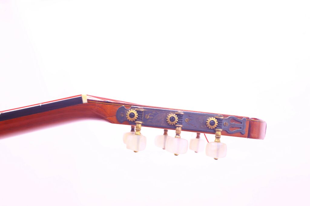 Close-Up Of The Jose Ramirez 1968 Flamenco Guitar Headstock, Featuring Tuning Pegs And Metallic Gears Set In A Reddish-Brown Wood Finish Against A White Background.