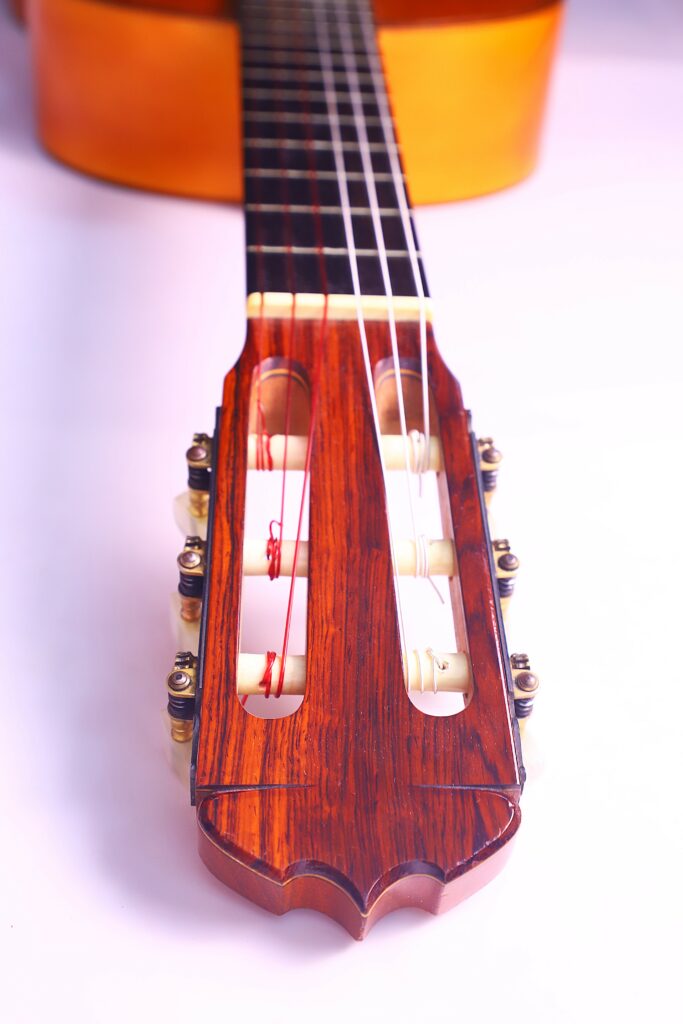 Close-Up View Of The Headstock And Tuning Pegs Of A Jose Ramirez 1968 Flamenco Guitar, With The Neck And Strings Extending Upwards And The Body Blurred In The Background.