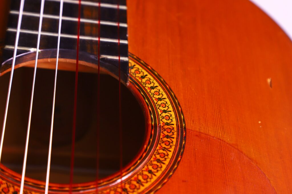 Close-Up Of A Jose Ramirez 1968 Flamenco Guitar Sound Hole And Strings, Highlighting The Intricate Decorative Rosette And The Warm, Polished Wood Texture Of The Guitar Body.