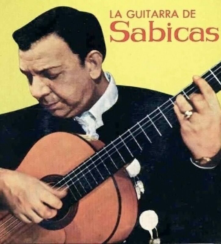 A Man In A Black Jacket Intently Plays A Classical Guitar Against A Yellow Background. The Text La Guitarra De Sabicas Appears In The Upper Right Corner.