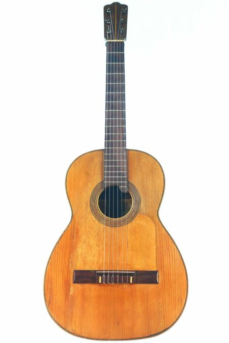 The Casa Gonzalez 1915 Classical Guitar features a wooden body, dark fretboard, and six strings, displayed against a plain white background.
