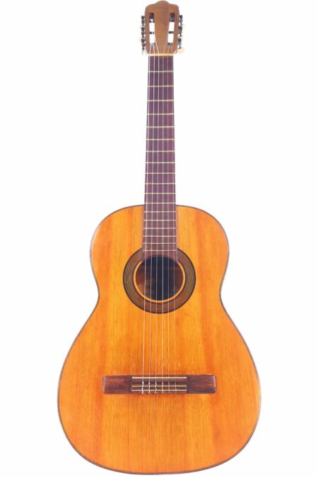 The Augustin Gaspar Cebrian 1935 Classical Guitar features a wooden body, six strings, a dark round sound hole, and a slotted headstock, shown against a white background.